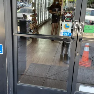 the reflection of a woman in a store window