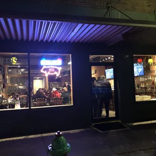 a man standing outside of a restaurant