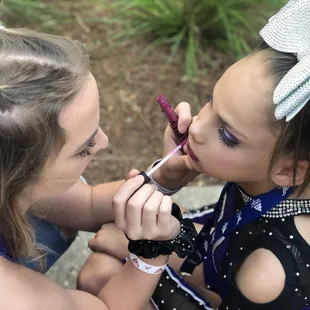 Coach Sharee helping my daughter put on her make up.