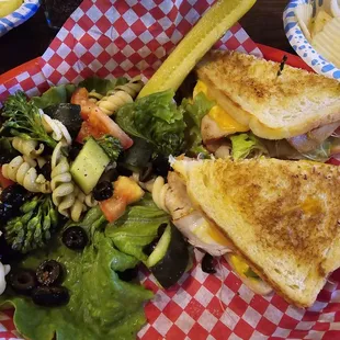 The liberty on sourdough with turkey, cheddar,  mustard, add mayo, tomato, lettuce, and sprouts with pasta salad