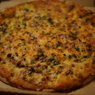 A delicious cauliflower, pistachio, onion, Montalban cheese pizza. Bought parbaked and baked at home.