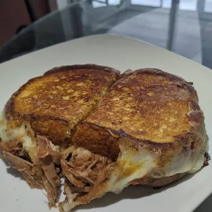 Barbecue Pulled pork with cheese on a brioche bread with a grilled mozzarella around the outside &amp; sweet cream butter