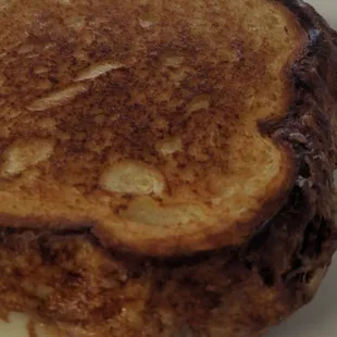 Two slices of cheese of your choice with grilled mozzarella around the outer edge of the sandwich on brioche bread salty sweet cream butter