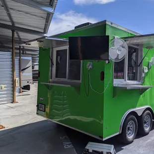 We have a TV for entertainment and two fans to keep our customers cool in line along with two service windows for social distancing