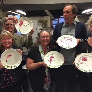 a group of people holding paper plates
