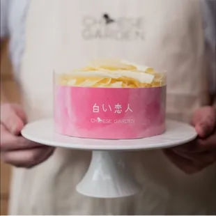 a person holding a cake