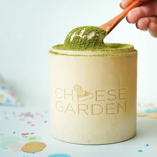 a person scooping a scoop of matcha