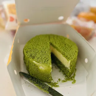 a green cake in a box