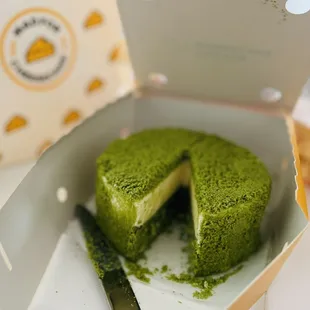 a green cake in a box