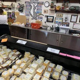 a display of cheeses in a store