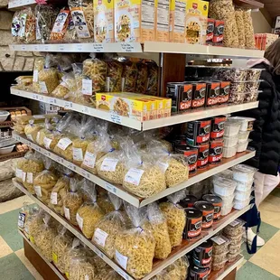 a display of cheeses and pastas