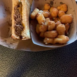 a basket of food and a glass of beer