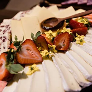 strawberries and cheese on a platter