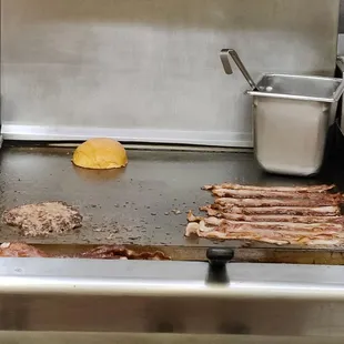 Toasting the bun, too... Besides some bacon and my patty