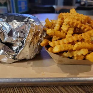 a hamburger and fries on a tray