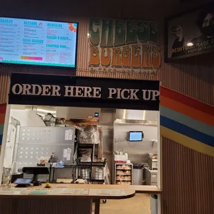 a counter with a menu on the wall