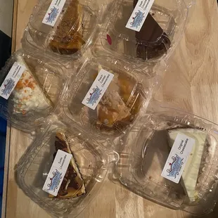 a variety of cheesecakes in plastic containers
