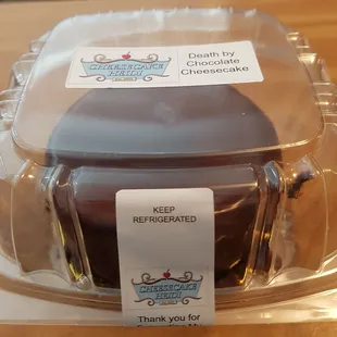 a chocolate cake in a plastic container