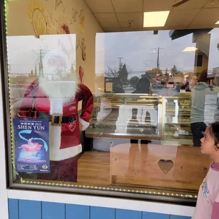 a little boy looking in the window