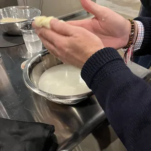 a person holding a piece of cheese in their hand