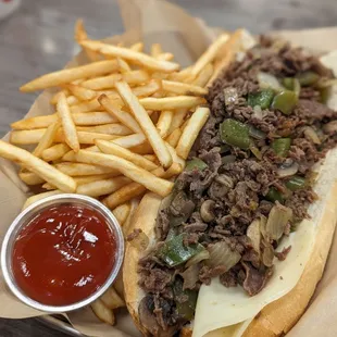 Large steak supreme with provolone and extra meat, and side of fries