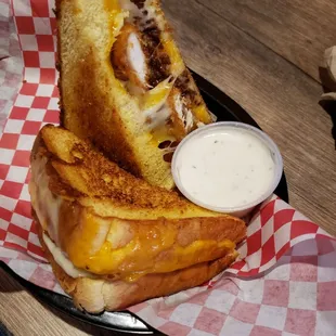 a grilled cheese sandwich with a side of dip