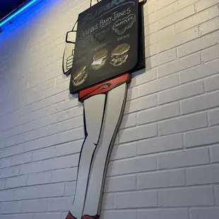 a neon sign on a brick wall