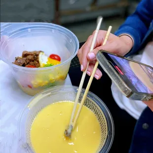 two bowls of food and chopsticks