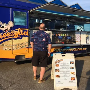 a man standing in front of a food truck