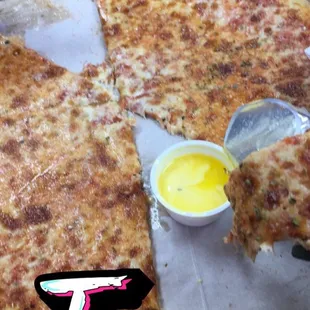 a person taking a slice of cheese pizza