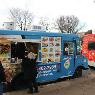 two people ordering food from a food truck