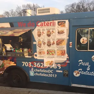 a food truck with a menu on the side