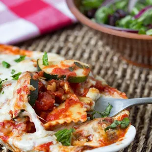 a plate of lasagna and a bowl of salad