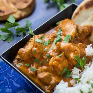 a plate of food with rice and meat