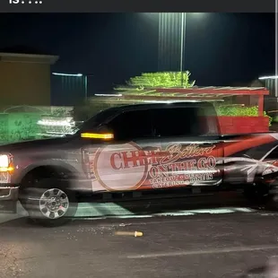 Dumping trash out of her truck in a parking lot