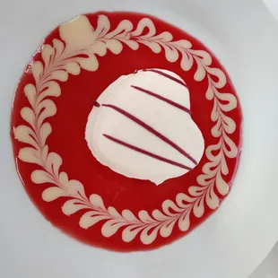 Dessert: heart shaped white chocolate gelato with fresh raspberry guava puree