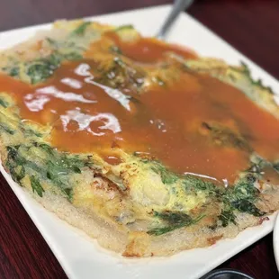 an omelet with sauce on a plate