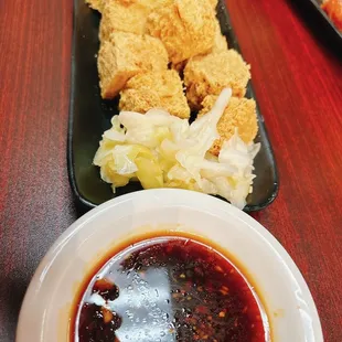 a plate of fried food and dipping sauce