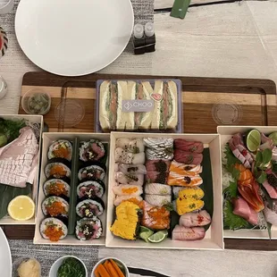 a variety of sushi on a wooden tray