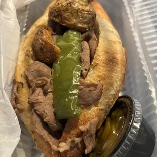 a sandwich with meat and pickles