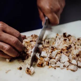 Chef Curry chopping grilled chicken for our house made chicken tortilla soup.