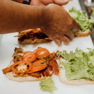 Assembling the best sandwich in town.