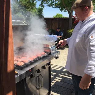 Grilling MANY burgers poolside!