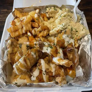 Chicken wing combo with smothered fries and pasta. SOOOOO GOOD!