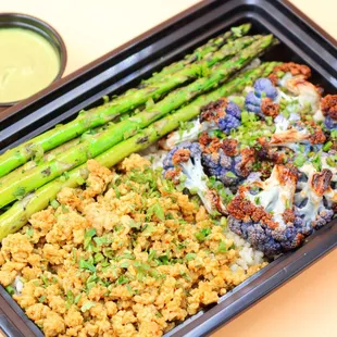 a meal of broccoli, cauliflower, rice, and asparagus
