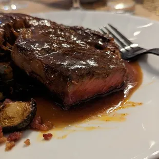 Perfectly cooked med-rare steak with pan sauce.