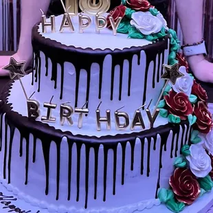 a cake with drips and roses