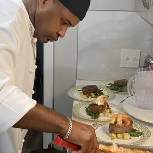 Chef Gason plating up the dinners