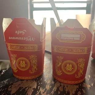 two take out boxes on a table