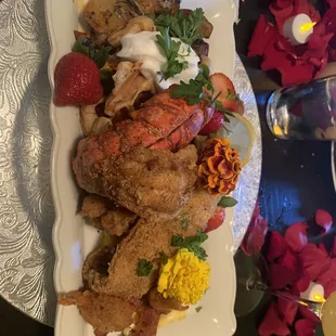 Fried lobster tail, catfish, chicken, shrimp, bacon, cheese eggs, savory waffles, potatoes